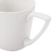 A close-up of a CAC Bone White Porcelain coffee cup with a handle.