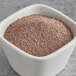 A bowl of Callebaut ground dark chocolate powder.