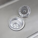 A close-up of a stainless steel Regency utility sink with a drain.