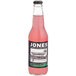 A case of Jones Watermelon Soda on a table with a bottle of pink liquid.