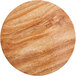 An Enjay round wood cake board with a marble and wood surface.