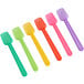 A group of Choice plastic gelato spoons in assorted colors.