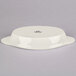 A white Tuxton oval dish with a lid.
