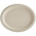 A white World Centric oval compostable fiber plate with a plain edge.