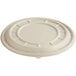 A white compostable fiber disc with a circular design and holes.