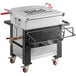 A Backyard Pro Cajun Seafood Boiler Cart with a large metal container on wheels with red handles.