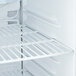 A close up of an Avantco countertop display refrigerator with shelves.