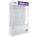 An Avantco white refrigerated air curtain merchandiser with customizable panel.