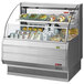 A Turbo Air low profile horizontal refrigerated open curtain merchandiser with food on display.