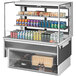 A white Turbo Air refrigerated display case with drinks and cans inside.