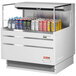 A white Turbo Air horizontal refrigerated curtain merchandiser with cans of soda and energy drinks inside.