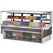 A Turbo Air white drop-in refrigerated display case with drinks and beverages on shelves.