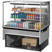 A Turbo Air stainless steel drop-in refrigerated open display case with drinks and snacks inside.