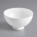 A white Choice round plastic mini bowl on a gray surface.