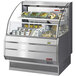 A Turbo Air low profile horizontal air curtain display case with food displayed inside.