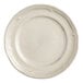 An Acopa Condesa warm gray porcelain plate with a scalloped wide rim.