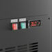 A close up of the digital display on the Avantco black deli case with orange numbers.
