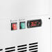 The digital temperature display on an Avantco white refrigerated deli case.