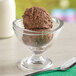 A glass bowl with a scoop of Oringer Van Daak chocolate ice cream.