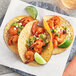 McCormick Culinary Mesquite Grill Seasoning on shrimp tacos with lime.