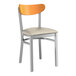 A Lancaster Table & Seating metal chair with a light gray vinyl seat and cherry wood back.