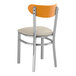 A Lancaster Table & Seating metal chair with a cherry wood back and a light gray cushioned seat.