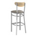 A Lancaster Table & Seating Boomerang bar stool with dark gray vinyl seat and driftwood back.