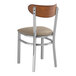 A Lancaster Table & Seating Boomerang series wood and metal chair with a taupe vinyl seat.