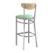 A Lancaster Table & Seating bar stool with seafoam vinyl seat and driftwood back.