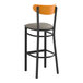 A Lancaster Table & Seating black bar stool with a dark gray cushion and cherry wood back.