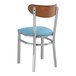 A Lancaster Table & Seating metal chair with a blue cushion.