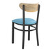 A Lancaster Table & Seating Boomerang series wooden chair with a blue vinyl seat and driftwood back.