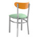 A Lancaster Table & Seating metal chair with a seafoam vinyl cushion and cherry wood back.
