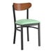 A Lancaster Table & Seating black chair with a seafoam green cushion.