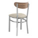 A Lancaster Table & Seating Boomerang Series wood and metal chair with a light gray cushioned seat.
