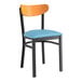 A Lancaster Table & Seating Boomerang chair with a blue vinyl seat and cherry wood back.