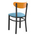 A Lancaster Table & Seating black chair with blue vinyl seat and cherry wood back.