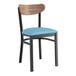 A Lancaster Table & Seating Boomerang Series wooden chair with a blue vinyl cushion and black frame.