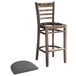 A Lancaster Table & Seating wooden ladder back bar stool with a dark gray vinyl seat detached from the chair.