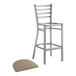 A Lancaster Table & Seating metal ladder back bar stool with a taupe cushion on the seat.