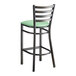 A Lancaster Table & Seating distressed copper ladder back bar stool with a seafoam vinyl padded seat.