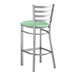 A Lancaster Table & Seating clear coat finish ladder back bar stool with a seafoam vinyl padded seat.