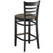 A Lancaster Table & Seating black wood ladder back bar stool with a taupe cushion.