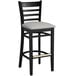 A Lancaster Table & Seating black wood ladder back bar stool with light gray vinyl seat on a white background.