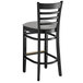 A Lancaster Table & Seating black wood ladder back bar stool with a light gray vinyl seat.