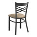 A Lancaster Table & Seating black metal chair with a taupe cushion.