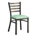 A Lancaster Table & Seating distressed copper metal ladder back chair with a seafoam vinyl padded seat.
