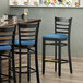 Lancaster Table & Seating Black Finish Wooden Ladder Back Bar Height Chair with Blue Padded Seat Main Thumbnail 1