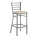 A Lancaster Table & Seating metal bar stool with a light gray vinyl cushion.