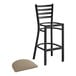 A Lancaster Table & Seating black ladder back bar stool with a taupe cushion seat.